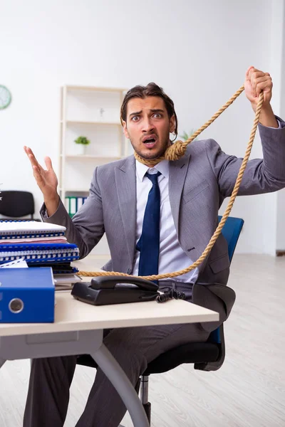 Young male employee unhappy with excessive work — Stock Photo, Image