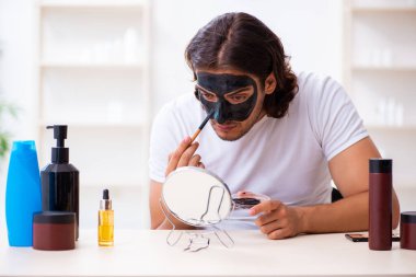 Genç erkek kozmetikçi blogu için video kaydediyor.