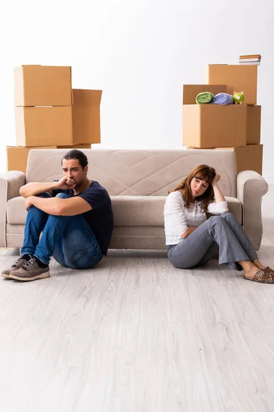 Young pair and many boxes in divorce settlement concept