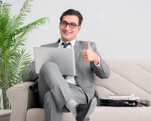 Businessman with laptop notebook sitting in sofa — Stock Photo, Image