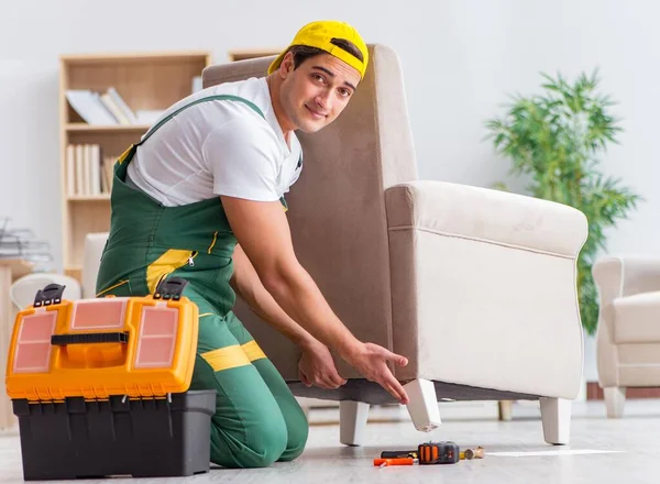 Worker repairing furniture at home