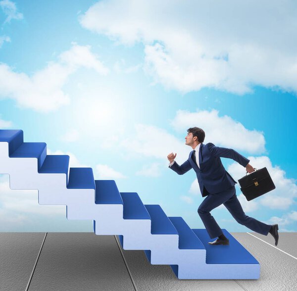 Businessman climbing career ladder in business concept