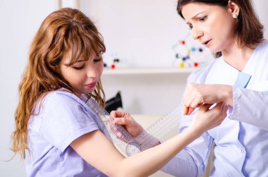 Kadın doktor goniomet ile hastaların eklem esnekliği kontrol