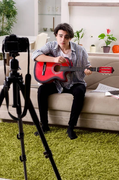 Young guitar player recording video for his blog — Stock Photo, Image