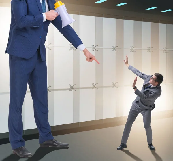 Bad angry boss shouting at employee with loudspeaker — Stock Photo, Image