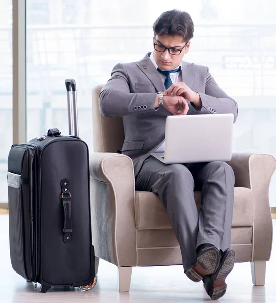 Young businessman in airport business lounge waiting for flight