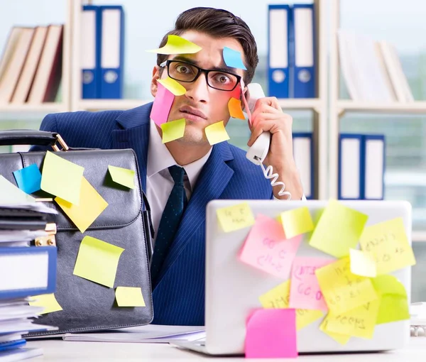 Businessman with reminder notes in multitasking concept — Stock Photo, Image