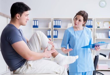 Hastanede yaralanma kontrolü sırasında doktor ve hasta.