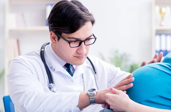 Läkaren undersöker gravid kvinnlig patient på sjukhus — Stockfoto