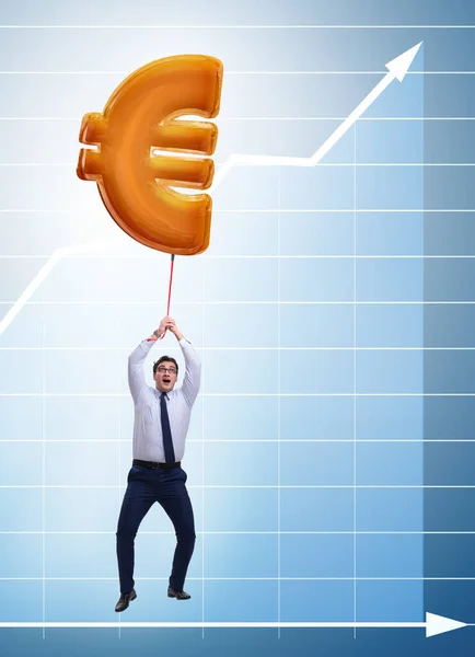 Uomo d'affari che vola su euro segno palloncino gonfiabile — Foto Stock