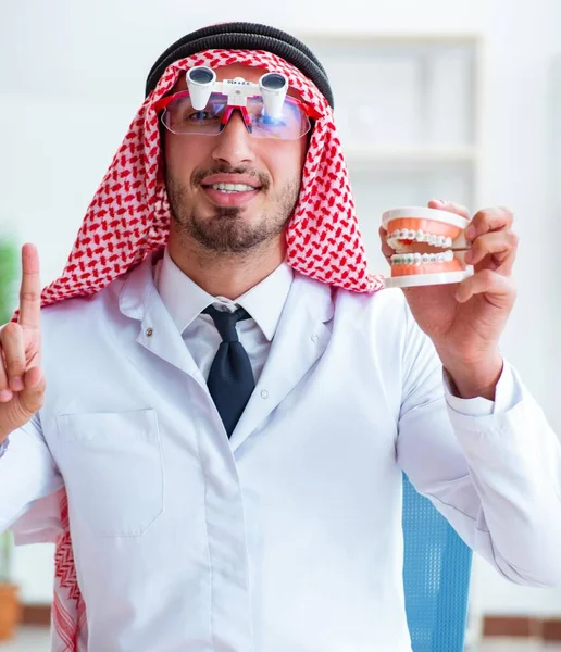 Odontólogo árabe trabajando en un nuevo implante dental — Foto de Stock