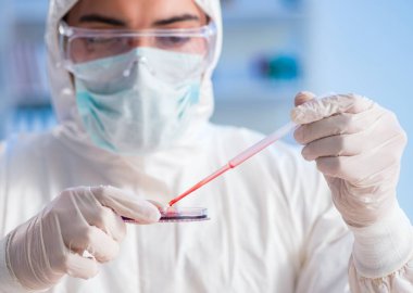 Laboratuvar asistanı hastanede kan örneklerini test ediyor.