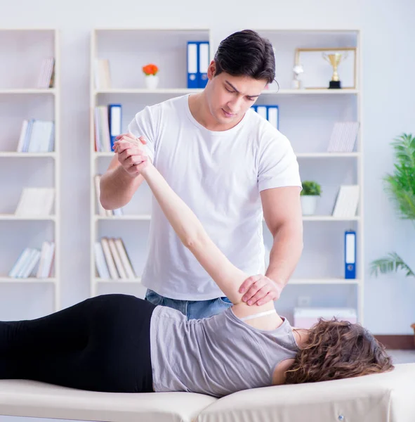 Young doctor chiropractor massaging female patient woman — Stock Photo, Image