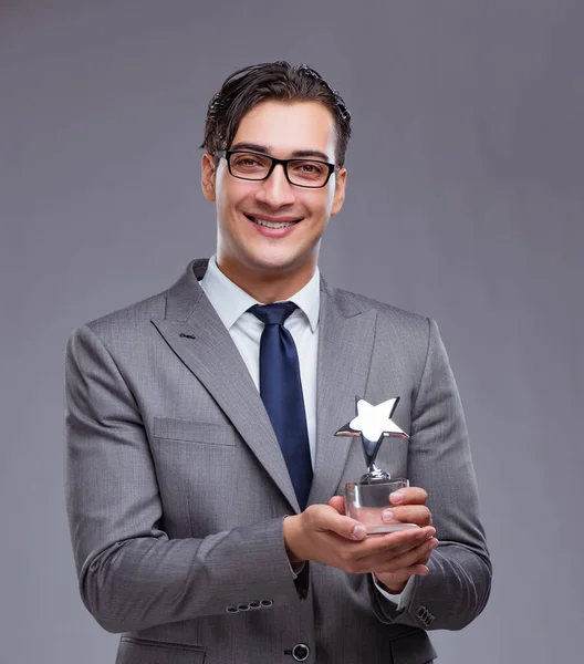 Businessman holding star award in business concept — Stock Photo, Image