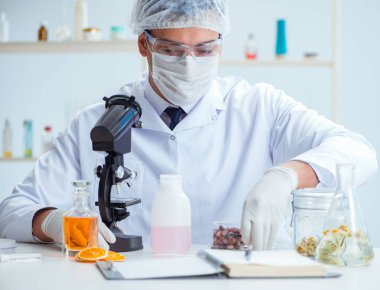 Laboratuvarda parfüm karıştıran bir kimyager.