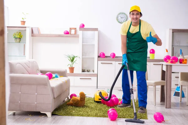 Young male contractor doing housework after party — Stock Photo, Image