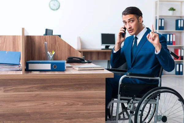 Young male employee in wheel-chair — Stock Photo, Image