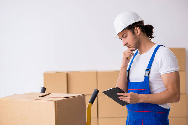 Young male professional mover doing home relocation
