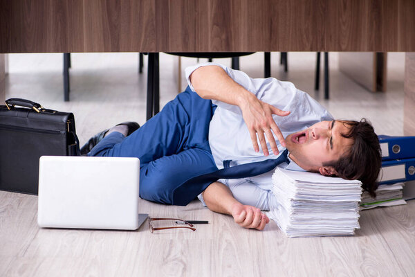 Young male employee and too many work in the office