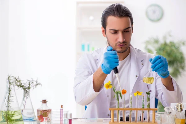 Young male chemist in perfume synthesis concept — Stock Photo, Image