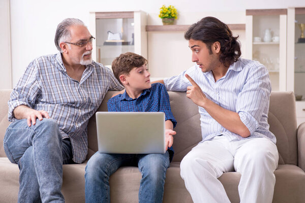 Boy and his father and his grandfother indoor