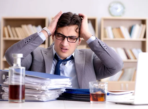 Young businessman drinking from stress — Stock Photo, Image