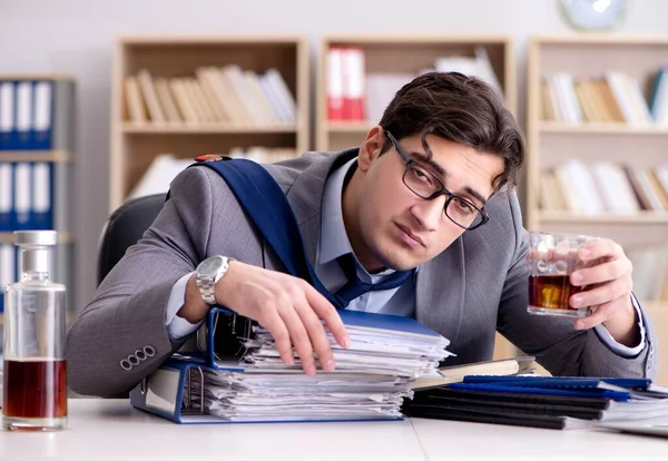 Young businessman drinking from stress — Stock Photo, Image