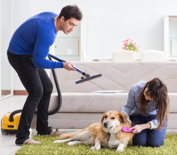 Husband cleaning house from dog fur