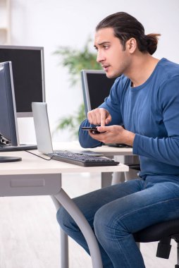 Ofiste çalışan genç bir erkek.