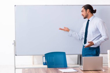 Young male employee in business presentation concept