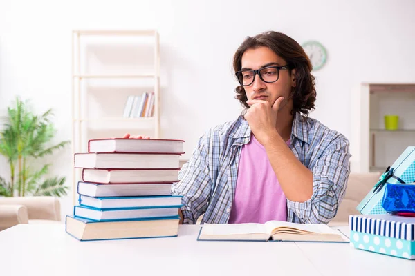 Young male student preparing for exams during Christmas — Stockfoto