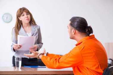 Young man meeting with advocate in pre-trial detention clipart