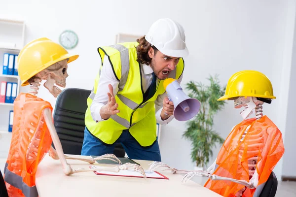 Funny construction business meeting with boss and skeletons — Stock Photo, Image