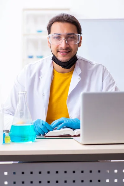 Young male chemist student preparing for exam — Stock Photo, Image