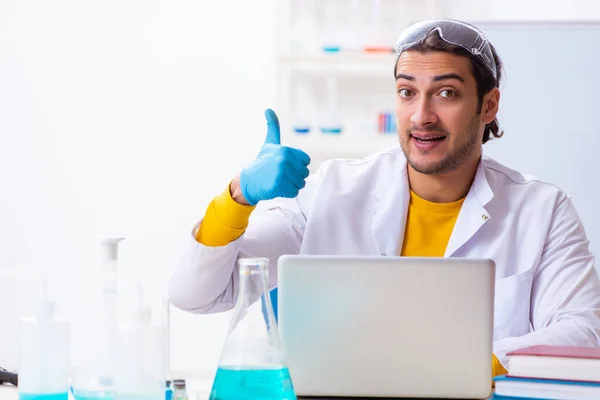 Young male chemist student preparing for exam — Stock Photo, Image