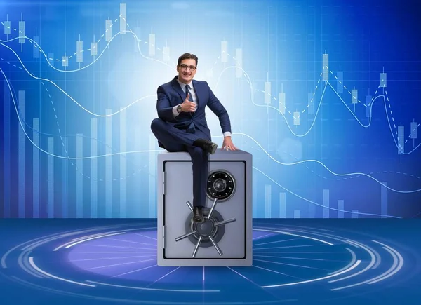 Businessman sitting on top of safe — Stock Photo, Image