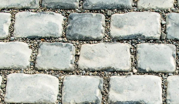 Estrada pavimentada com pedras de calhau para o seu fundo — Fotografia de Stock