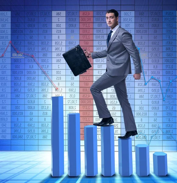 Businessman climbing bar charts in business concept — Stock Photo, Image