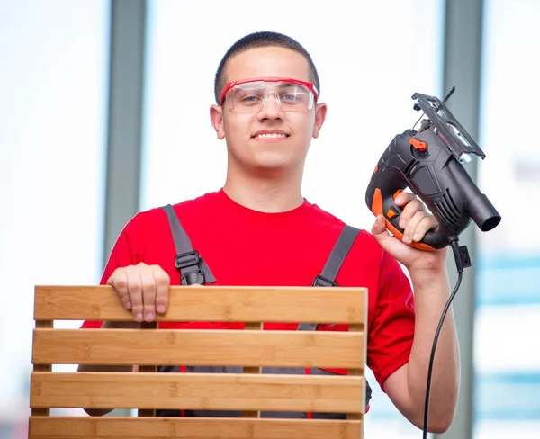 Young furniture carpenter in industrial concept — Stock Photo, Image