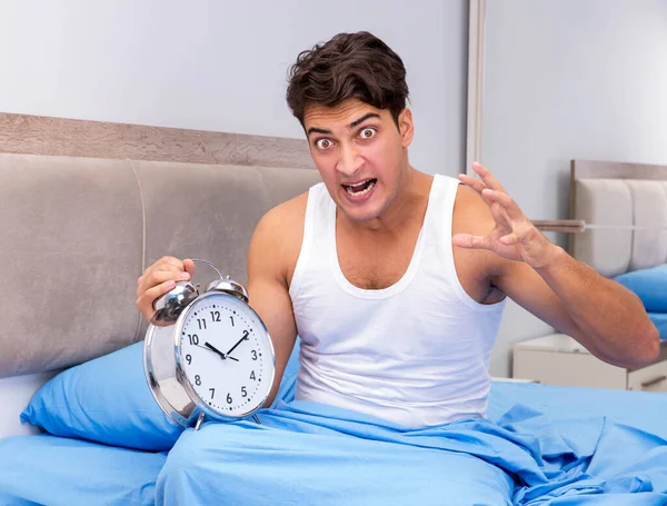 Man having trouble waking up in morning