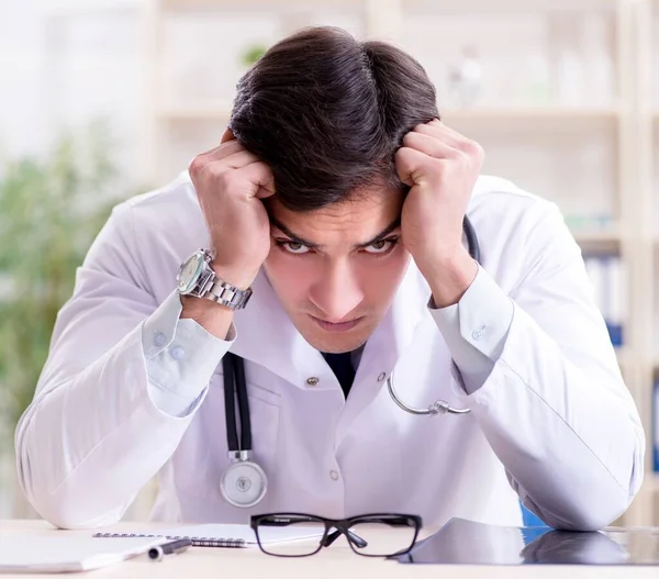 Young doctor sitting in the office — Stock Photo, Image