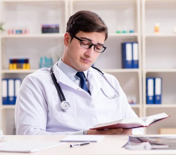 Young doctor sitting in the office — Stock Photo, Image