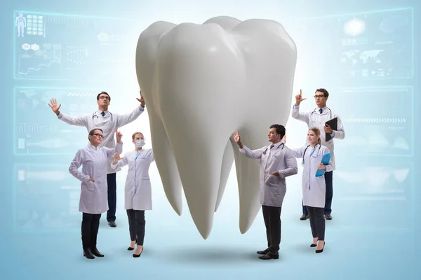 Doctors examining giant tooth in dental concept — 图库照片