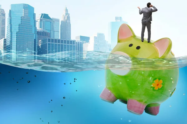 Businessman in debt concept with piggybank — Stock Photo, Image