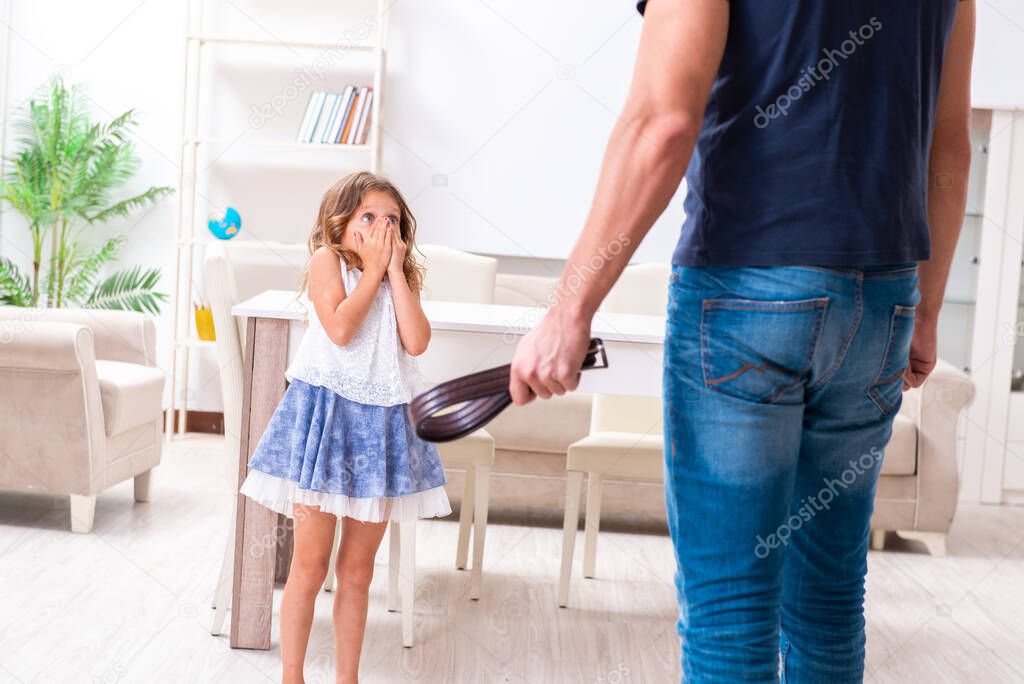 Angry father punishing his daughter