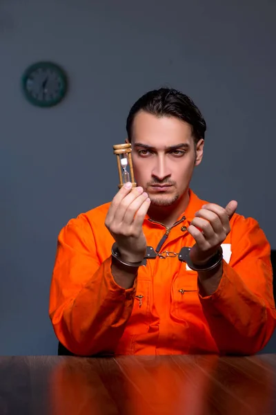 Young convict man sitting in dark room — Stock Photo, Image