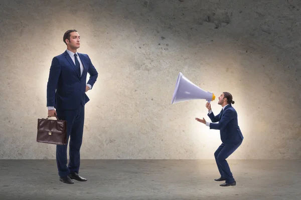 Businessman shouting through large loudspeaker — Stock Photo, Image