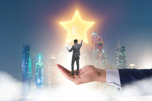 Businessman held on hand reaching out for stars — Stock Photo, Image