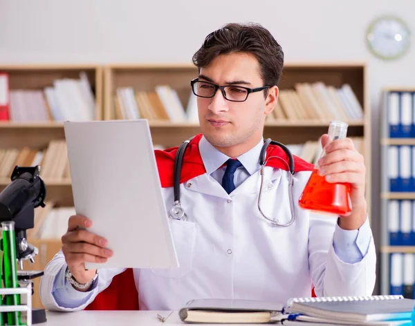 Superhero doctor working in the lab hospital