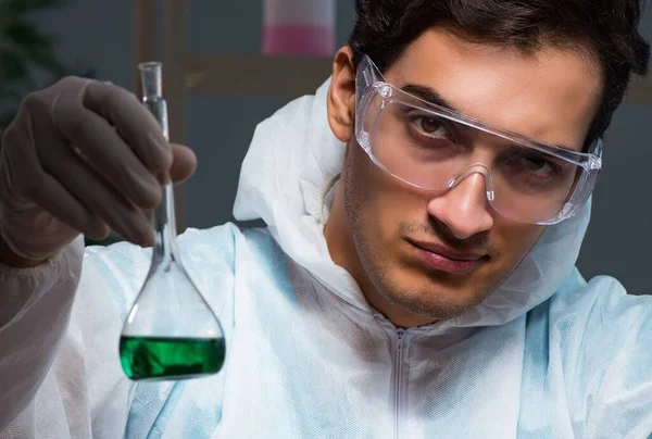 Young male lab chemist late at night in overtime time — Stock Photo, Image